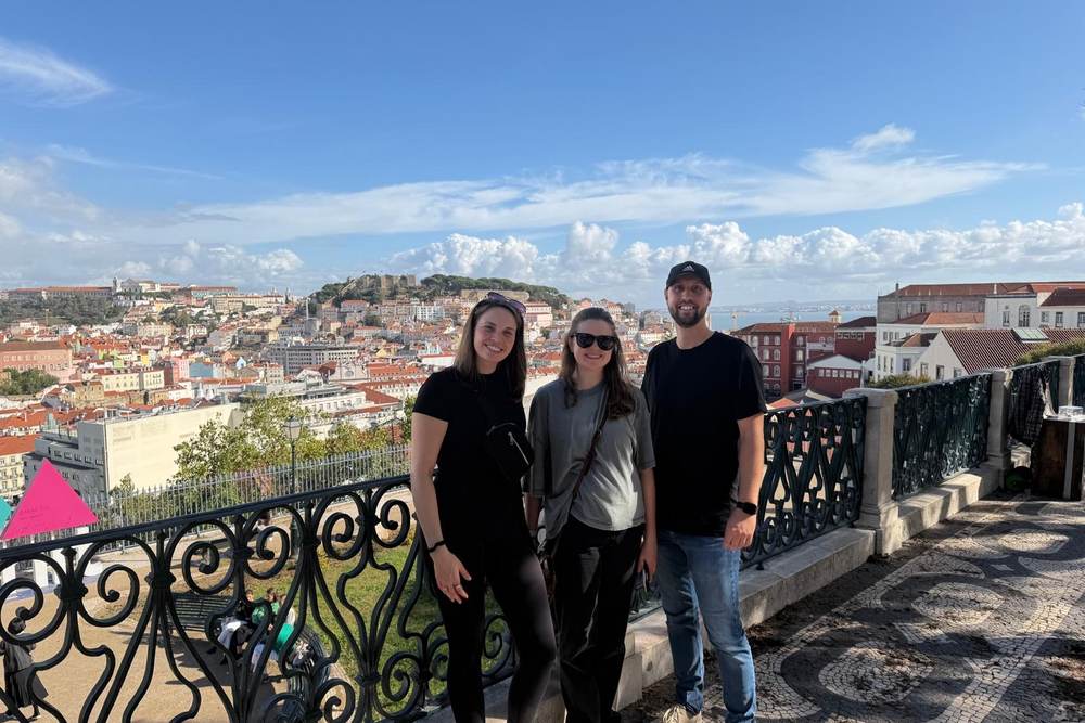 Three lab members at a viewpoint overlooking Lisbon